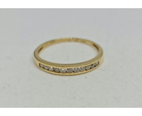 A hallmarked 18ct yellow gold diamond half eternity ring, set with eleven round brilliant cut diamonds, ring size R.