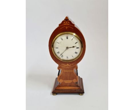 A mahogany balloon shaped mantle clock with inlaid border and lyre to front. 27cm.