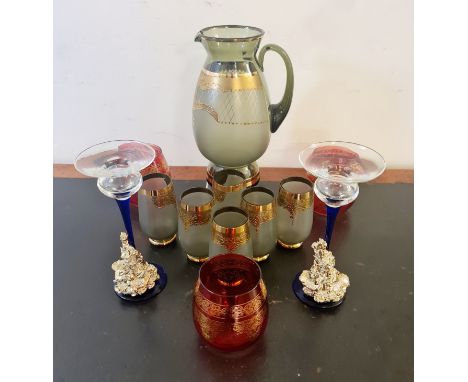 A collection of Italian coloured glass lemonade set drinking glass and candlestick.
