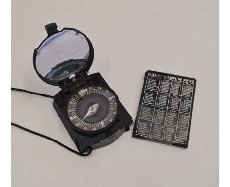 A German WW2 Busch compass together with a Kalendarium 1943 calendar mirror.