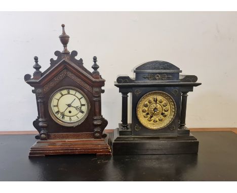 A gothic style mantle clock with a black painted mantle clock.