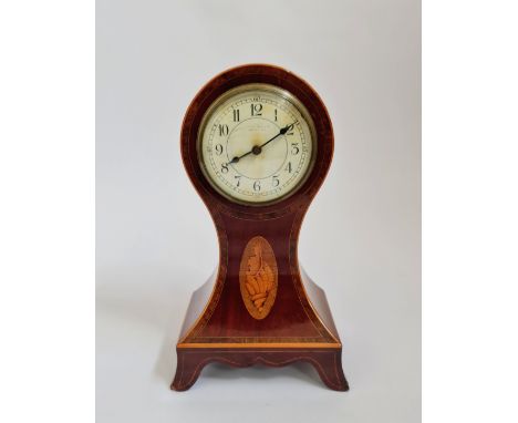 A mahogany balloon shaped mantle clock with inlaid border and shell to front. 28cm.