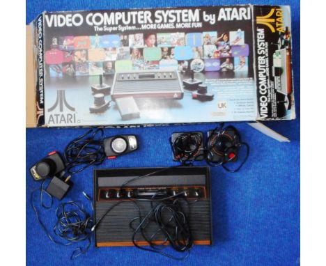 Atari Video Computer System. Model CX-2600. 3 games - Combat, Backgammon and Space Invaders. Boxed. With original packaging.