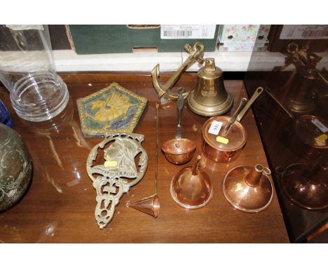 A collection of various copper and brass ware including ladle, funnels, candle snuffer, bell, Queen Victoria commemorative ha