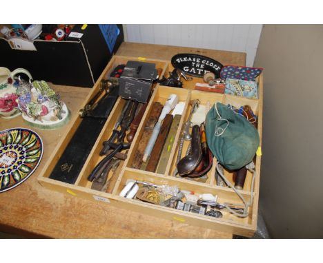 A wooden box and contents including various vintage hand tools, spirit levels, cloth badges, cased pipe, penknives, Bosun's w