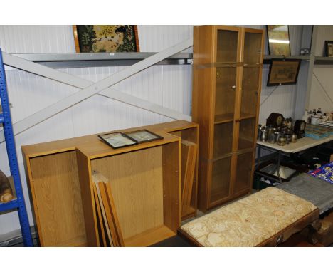 A light oak effect glazed cabinet and three shelves 