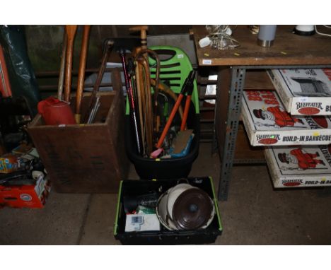 A garden trolley with contents of various garden tools, Tilley lamp, garden sprayer, walking sticks and a box containing enam