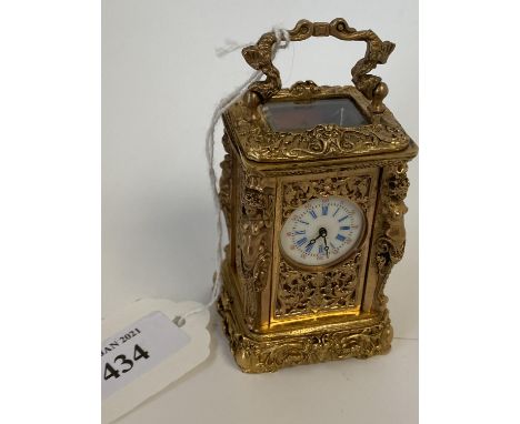Miniature ornately decorated brass carriage clock with enamel dial.  Good condition not tested working  7 cm H including hand