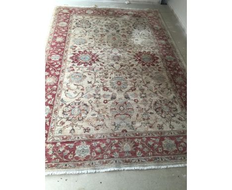 A Paskistani 100% hand knotted woollen oriental carpet, with soft fawn ground with pinks, 189 x 273cm (generally good conditi