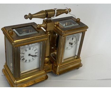 Small double brass carriage clock set one as a clock, the other as a barometer.  10.5 cm H including handle,  Good condition 
