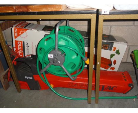 A Flymo electric garden vacuum & a hose pipe