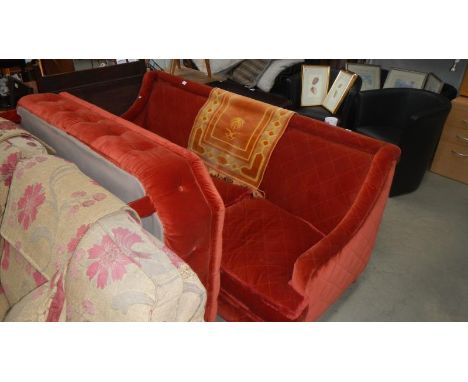 A red 3 seater sofa with large foot rest