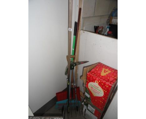 A quantity of tools including rakes etc.