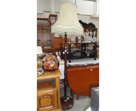 A wooden standard lamp