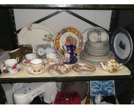 A shelf of assorted tea & dinnerware