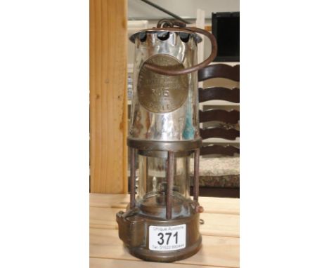 A protector lamp and Lighting co. ltd. type GR65 miner's lamp.