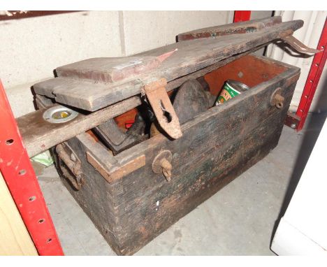 An old wooden chest with hand tools etc (approximately 4ft long)