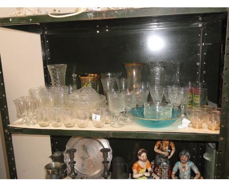 A shelf of glassware including vases & drinking glasses etc.