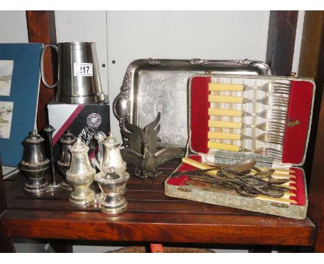 A shelf of silver plate items