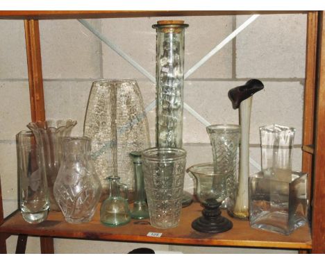 A shelf of glassware including vases
