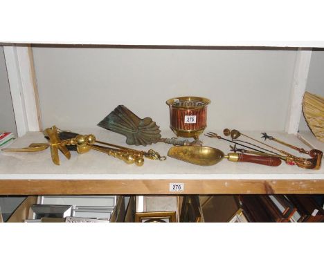A shelf of brass & copperware