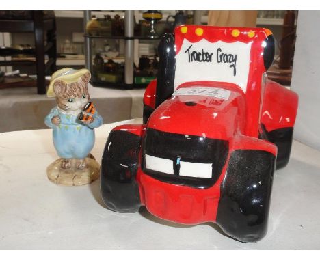 A Royal Albert tom kitten with butterfly and a red tractor pottery money box.