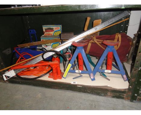 A shelf of tools including car axle stands etc.