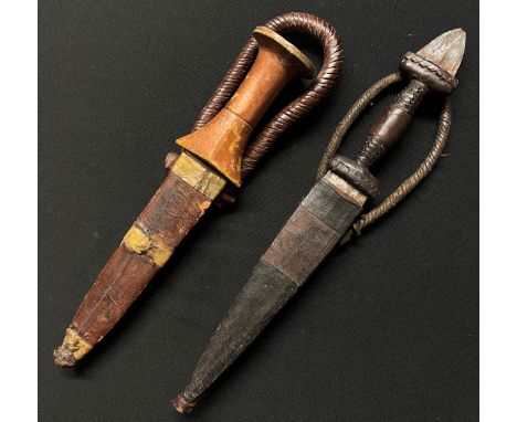 Two African Sleeve Daggers: one with gold painted wooden grip with 134mm long double edged blade, overall length 215mm, compl