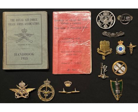 A collection of mixed insignia and two manuals: USAF cap badge, collar dog and miniature Air Crew wings by Meyer NY: Royal Si