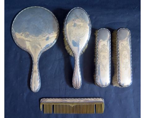 A George V Silver Backed Five Part Dressing Table Set including hand mirror, comb and three brushes, Birmingham 1918, W G Sot