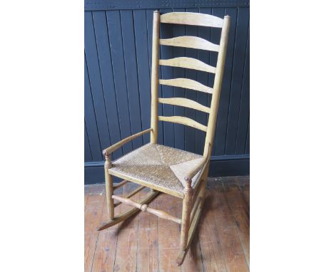 An 18th Century Oak High ladder Back Rocking Chair with remnants of contemporary painted decoration, 115cm high 