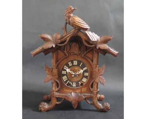 A Black Forest Cuckoo Clock with movement initialled G.H.S., 33cm 