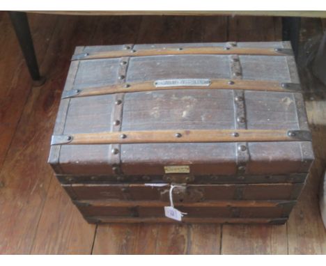 A Small Wood and Metal Bound Canvas Dome Top trunk and contents including collector's plates, 38cm wide. Hinges gone 