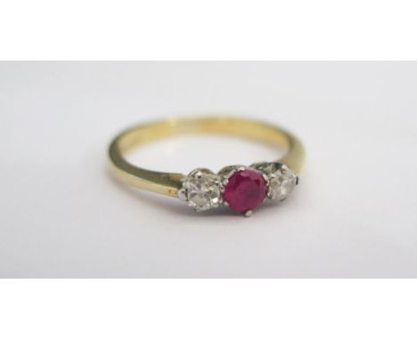 An 18ct Yellow Gold, Ruby and Diamond Three Stone Ring, size L.5, 2.9g 