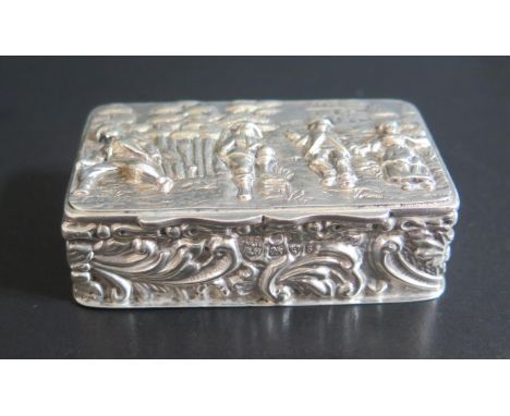 An Edward VII Silver Snuff Box decorated with embossed scene with figures in a landscape with house and foliate scroll sides,