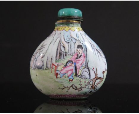A Chinese Enamel Snuff Bottle decorated with a seated figure amidst rocks and another with a brush, bone dipper,  reign mark 