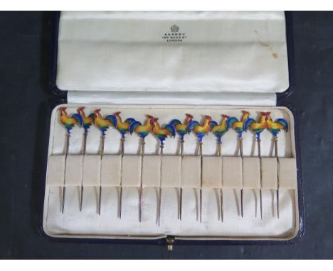 An Asprey Cased Set of Twelve Sterling Silver Gilt and Enamel Cocktail Sticks, stamped C&amp;C, 44g 