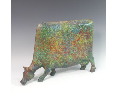 Lawson E. Rudge (b. 1936), a raku fired studio pottery sculpture of a Grazing Cow, with mottled metallic finish, H 36cm. Prov