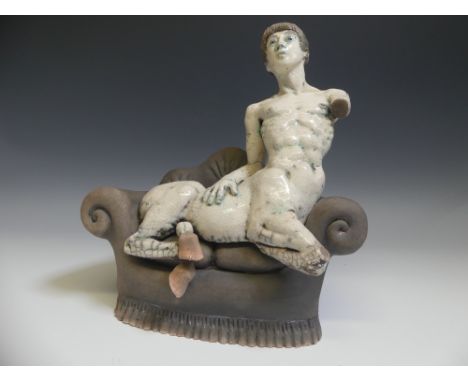 Lawson E. Rudge (b. 1936), a raku fired studio pottery sculpture of a Centaur on Sofa, H 31cm. Provenance: from the studio of