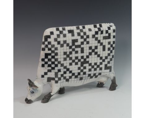 Lawson E. Rudge (b. 1936), a raku fired studio pottery sculpture of a Cow, with chess board design to one side, H 34cm. Prove