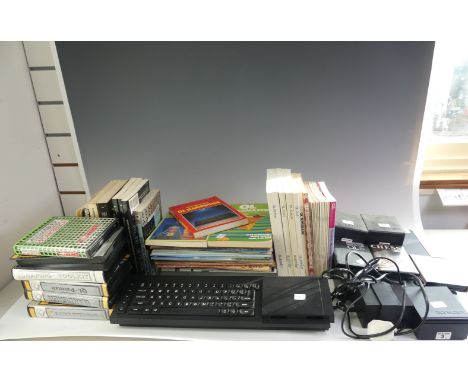 A vintage Sinclair computer QL, with power unit, dust cover, 16 assorted QL books, together with a selection of boxed QL game