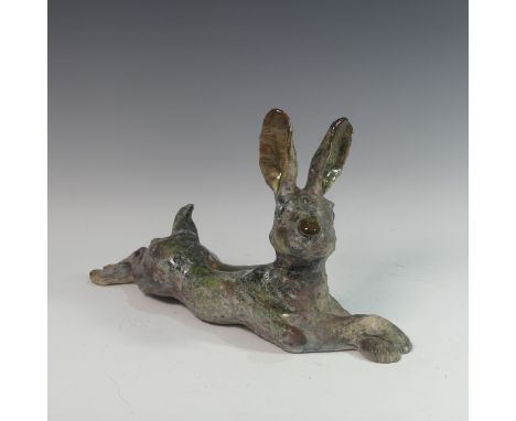 Lawson E. Rudge (b. 1936), a raku fired studio pottery sculpture of a Hare, modelled cross legged, L 47cm. Provenance: from t