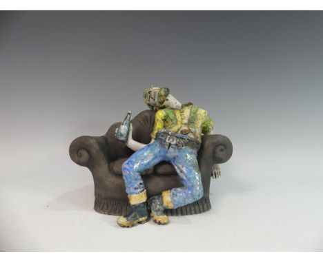 Lawson E. Rudge (b. 1936), a raku fired studio pottery sculpture of a Drunkard on Sofa, H 23cm. Provenance: from the studio o