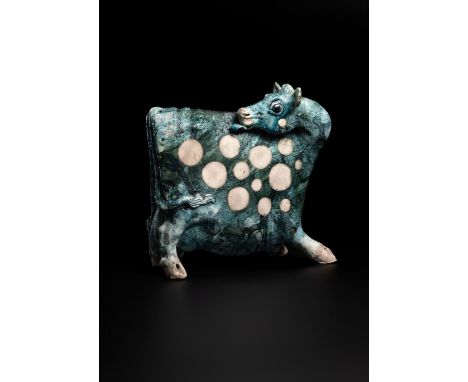 Lawson E. Rudge (b. 1936), a raku fired studio pottery sculpture of a Cow, with textured blue glaze and sgraffito decoration,