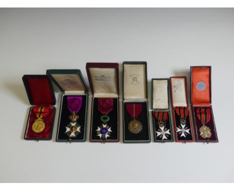 A collection of eight Belgian orders and medals, including a “Croix D’or d’officier” of the Order of Leopold, a Cross of the 