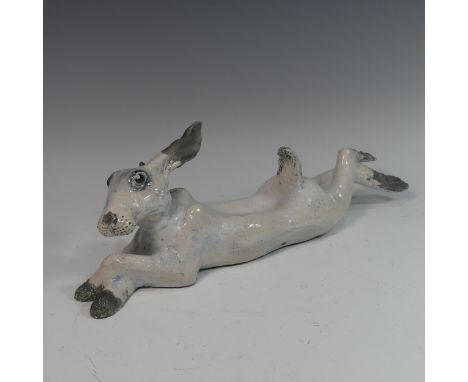 Lawson E. Rudge (b. 1936), a raku fired studio pottery sculpture of a Hare, modelled cross legged, L 44cm. Provenance: from t