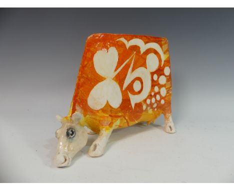 Lawson E. Rudge (b. 1936), a studio pottery sculpture of a Grazing Cow, with orange glazed decoration, numbered 22 to one sid