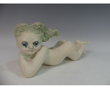 Lawson E. Rudge (b. 1936), a studio pottery sculpture of a Baby, modelled laying on her stomach, L 36cm. Provenance: from the