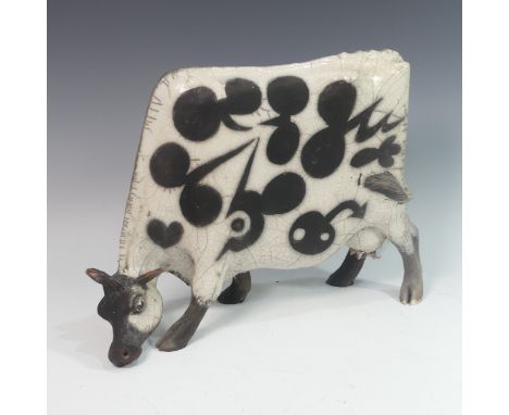 Lawson E. Rudge (b. 1936), a raku fired studio pottery sculpture of a Grazing Cow, with crackle glaze, numbered 2525, H 34cm.