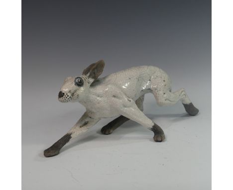 Lawson E. Rudge (b. 1936), a raku fired studio pottery sculpture of a Hare, modelled walking, L 48cm. Provenance: from the st